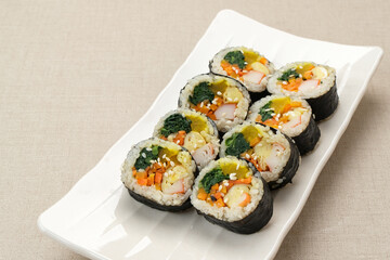Korean Rolled Gimbap, made of rice, cucumber, tuna, carrot, sausage, crab stick and wrapped with seaweed laver. 
