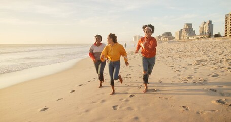 Friends, beach and running together on sand, outdoor freedom and weekend trip to ocean waves....