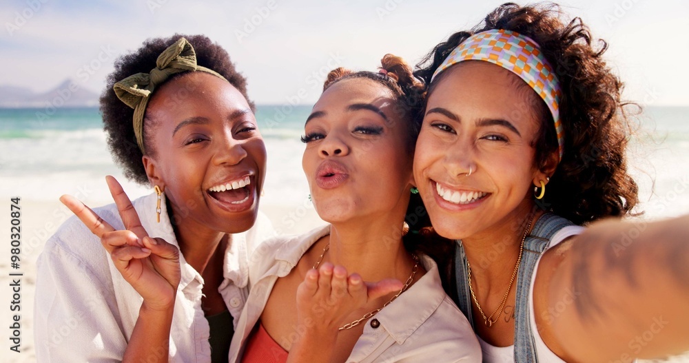 Poster Happy women, portrait and selfie with peace sign at beach for holiday or summer vacation together. Young, group or female people with smile, kiss or hug in joy for picture, memory or moment by ocean