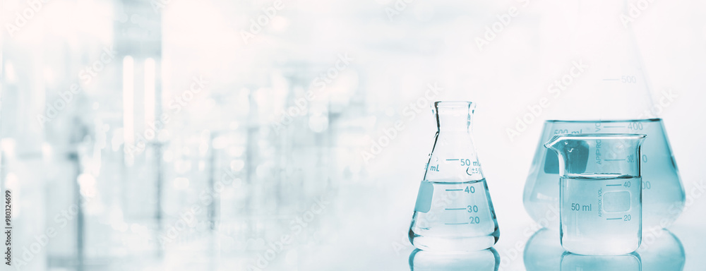Wall mural flask and beaker with water in research science lab white banner background