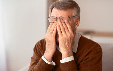 Eyesiht Problem. Unrecognizable Senior Man Massaging Tired Eyes Trying To Relieve Pain Sitting On...
