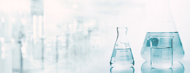 flask and beaker with water in research science lab white banner background