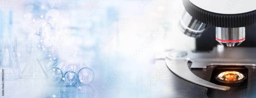 Wall mural microscope in science research lab with blue test tune banner background