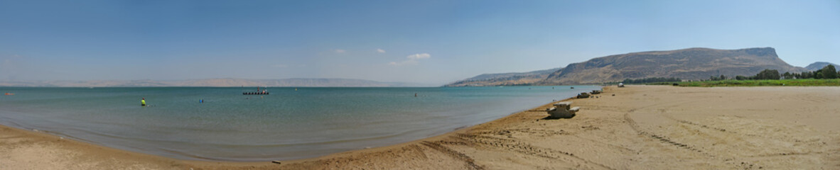 Kinneret lake or Sea of galilee coast and sand beach panoramic view on sunny day