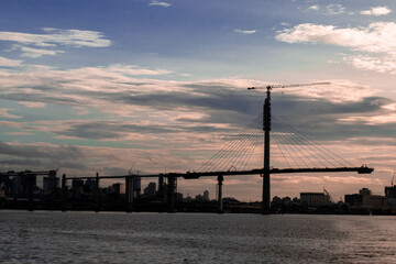 Fototapeta premium The Mactan Channel in Cebu, Philippines is a busy waterway that connects the Mactan Island and the mainland. It is home to numerous buildings, cargo ships, bridges, serving as a vital hub for trade