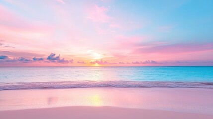 Obraz premium A colorful sunset painting the clouds over a tranquil beach with calm waves lapping the shore.