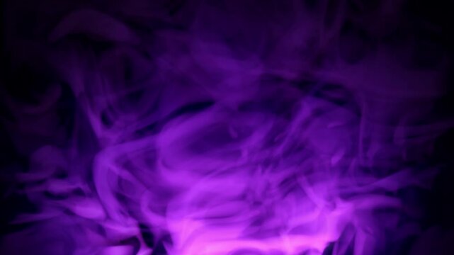 Seamless loop screensaver with pink purple smoke floating up on a black background. Magic steam animation with soft glow effect for science fiction, music festival and art performance. Looped 4K 30fps