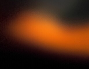  A diffused orange spotlight creates a circular shape on a dark surface