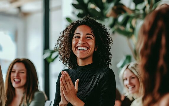 A team gathering where a leader is publicly acknowledging and celebrating a member'ss hard work, fostering a culture of gratitude.