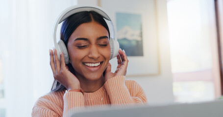 Home, headphones and woman with laptop, listening to music and happiness in living room. Apartment, person and girl with computer, headset and sound with song, radio, podcast for motivation and smile