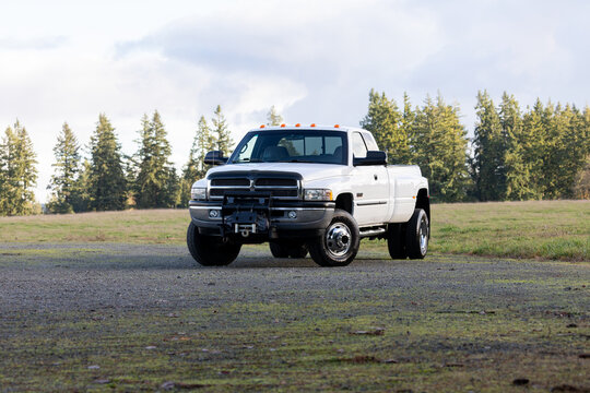 Portland, OR, USA - Dec 8, 2023 - 2001 White Dodge Ram 3500 dually Cummins 24 Valve Turbo Diesel 4x4  off-road American pickup truck exterior. High quality picture for download.