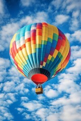 Fototapeta premium Vibrant Colorful Hot Air Balloon Soaring Through Picturesque Cloudy Sky on a Tranquil Adventure