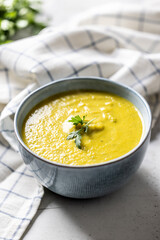 Healthy creamy vegetable soup in a blue bowl.