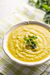 Healthy creamy vegetable soup in a white bowl.