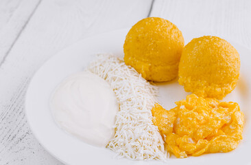 Delicious breakfast is served on a white plate standing on white wooden planks