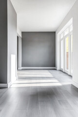 Fototapeta premium Bright and airy interior of a modern living space with light gray walls and wooden flooring in the afternoon sun