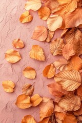 Fototapeta premium Richly colored autumn leaves scattered on a textured surface, capturing the essence of the season's transformation and beauty