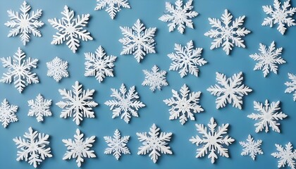 Assorted snowflake decorations on a light blue background.