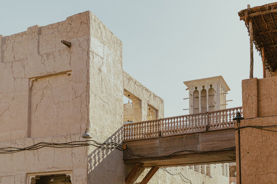 Traditional wind tower structure and stone bridge in Al Seef Old Dubai district