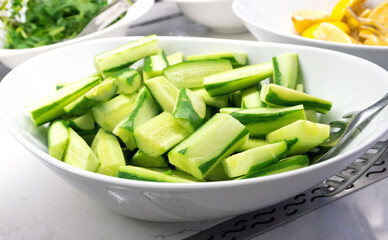 Large Plate with Fresh Cucumber Chunks - Side View