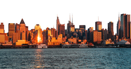 New York City skyline featuring tall buildings illuminated by the golden light of the setting sun,...