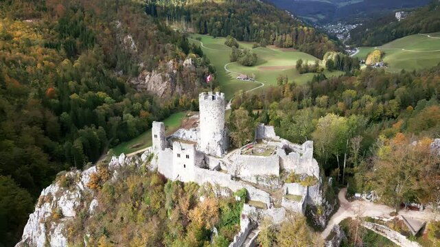 Crane drone shot of Neu-Falkenstein ruins in autumn in Balsthal in the canton of Soleure in Switzerland.