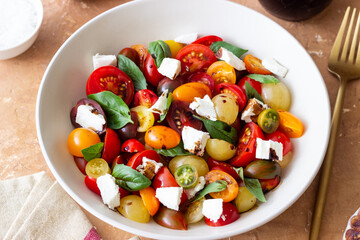 Salad with tomatoes, feta cheese, basil and balsamic vinegar. Healthy food. Vegetarian food.