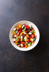 Salad with tomatoes, feta cheese, basil and balsamic vinegar. Healthy food. Vegetarian food.