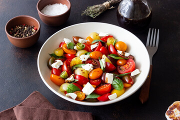 Salad with tomatoes, feta cheese, basil and balsamic vinegar. Healthy food. Vegetarian food.