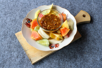 Rujak buah or fruit salad with spicy peanut sauce