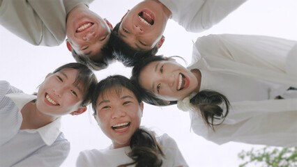 young beautiful people standing in circle and smiling excited at camera.