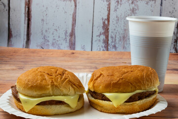 cheeseburger on a paper plate