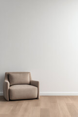 Cozy armchair in a minimalist room with light wood flooring and neutral walls during daylight hours