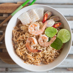 A bowl of instant noodles with seafood