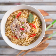 A bowl of instant noodles with minced pork
