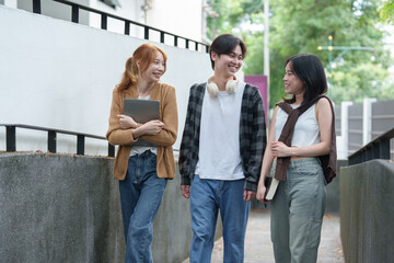Obraz premium Young Asian college students and groups of male and female students, field trips, reports, projects, theses, graduation studies. success concept Pride in knowledge and ability teamwork.