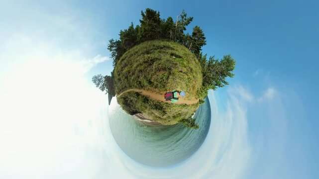 Backpacker Strolling Along a Scenic Tiny Planet Trail by the Ocean. Backpacker Walk Along a Beach Trail on a Miniature Planet, Surrounded by Vibrant Nature and Stunning Ocean Views