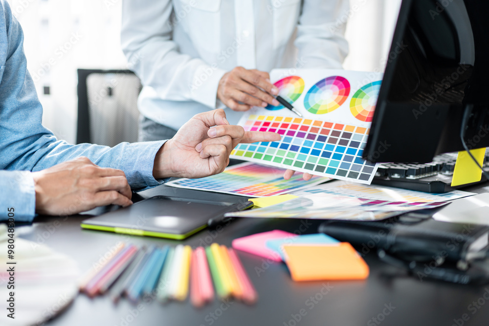Poster two creative graphic designer team working on color selection and drawing on graphic tablet, color s