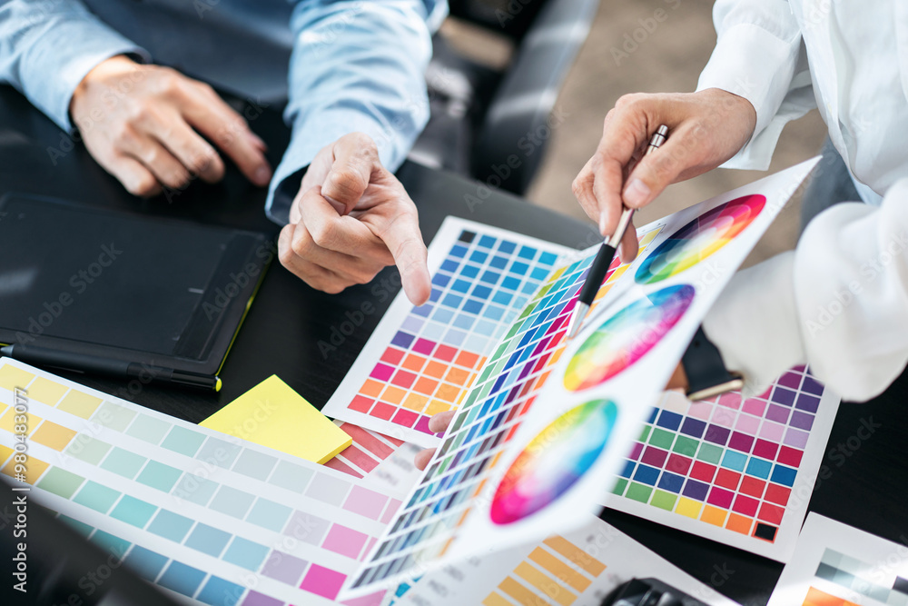 Poster two creative graphic designer team working on color selection and drawing on graphic tablet, color s