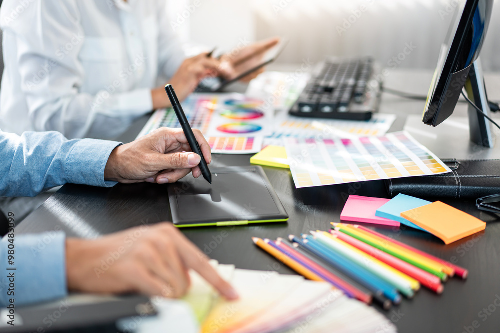 Aufkleber Two creative graphic designer team working on color selection and drawing on graphic tablet, Color swatch samples chart for selection coloring in inspiration to creativity at workplace