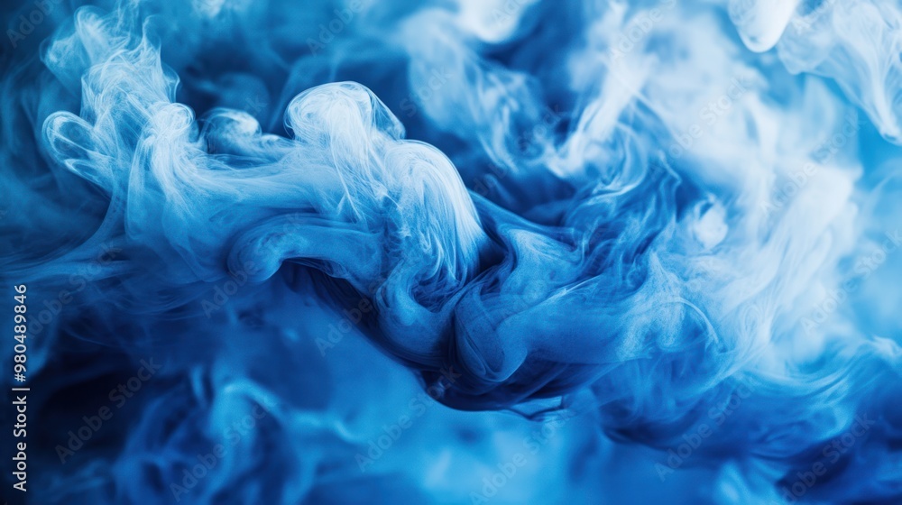 Poster fluid blue ink in water creating swirling and ethereal patterns, evoking a sense of tranquility clos