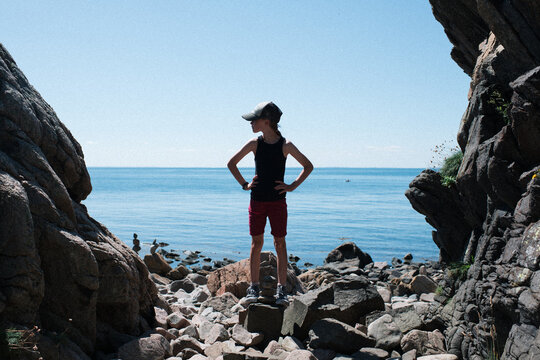 girl climbing rocks on the coast in Sweden