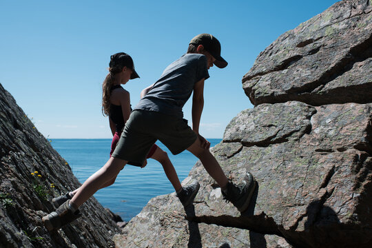 kids climbing rocks by the sea in Sk&aring;ne, Sweden