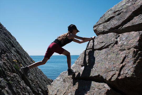 girl climbing rocks bouldering in Sk&aring;ne, Sweden