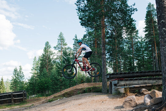 man riding a jump on a bike park in the mountains in Trysil