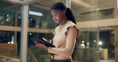 Tablet, office and black woman research at night, proofreading article or email publisher for...