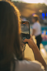Selective focus on modern cellular phone using for clicking pictures via camera, millennial woman...