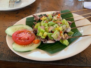 Balinese Grilled Squid with Dabu Dabu Chili Sauce. Spicy Indonesian condiment sambal made of tomato, garlic and shallot with lemon basil