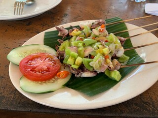 Balinese Grilled Squid with Dabu Dabu Chili Sauce. Spicy Indonesian condiment sambal made of tomato, garlic and shallot with lemon basil