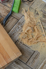 a bunch of wood shavings on the floor after cutting a board